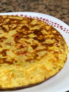 Una foto de Tortilla de patatas con cebolla y pimientos asados