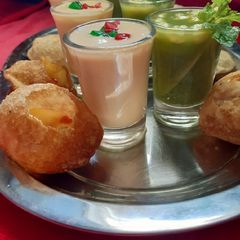 A picture of Mango stuffing with mango panipuri shots.