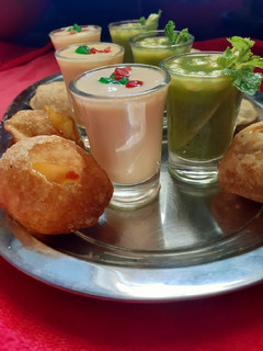 A picture of Mango stuffing with mango panipuri shots.