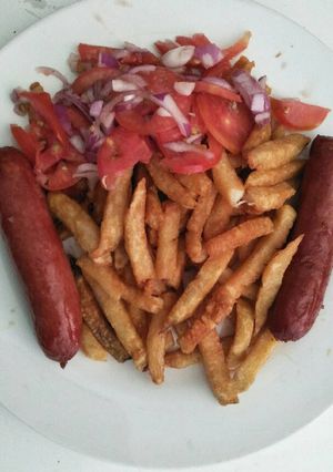 A picture of Fries with choma sausages.