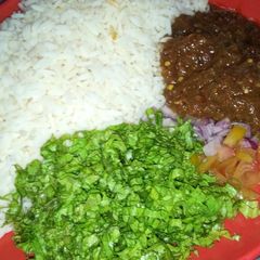 A picture of Rice and stew with salad.