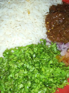 A picture of Rice and stew with salad.