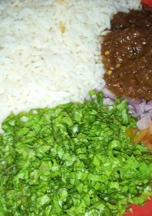 A picture of Rice and stew with salad.