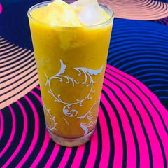 A picture of Mango juice with scoop of ice cream.