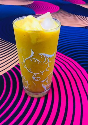 A picture of Mango juice with scoop of ice cream.