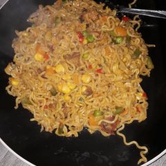 A picture of Indomine with carrots,Green peas,and sausages.