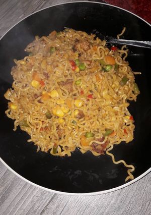 A picture of Indomine with carrots,Green peas,and sausages.