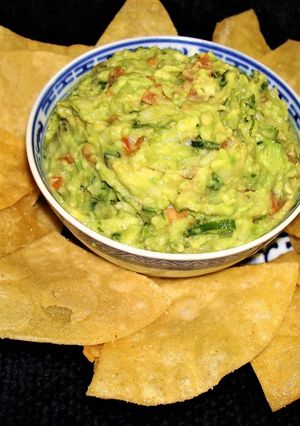 A picture of Avocado with Cucumber and Corn Chips.