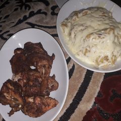 A picture of Mashed potatoes and oven grilled chicken.