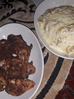 A picture of Mashed potatoes and oven grilled chicken.