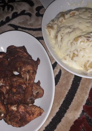 A picture of Mashed potatoes and oven grilled chicken.