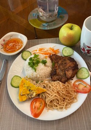 A picture of Vietnamese Broken Rice with Grilled Pork Chop, Shredded Pork, and Egg Meatloaf (Cơm tấm sườn bì chả).