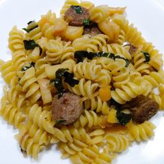 A picture of Rotini with sausage and apples.