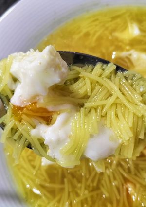 A picture of Vegetable and Turmeric Soup with Noodles and Poached Egg.