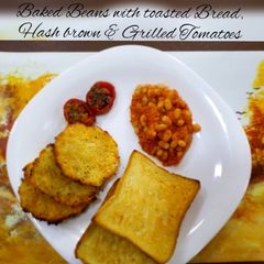 A picture of Baked Beans with toasted Bread,Hash brown & grilled tomatoes.