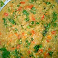 A picture of Masala oats with lots of vegetables.