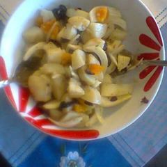 A picture of Potato salad with orange and onion.