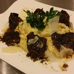 A picture of Bianco Meats-Grilled Bourbon Steak Tips on Creamy Parm Polenta !.