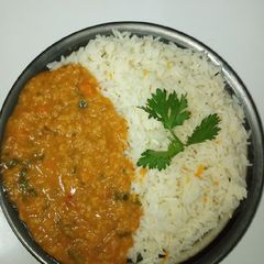 A picture of Garlic and carrot rice with lentils.