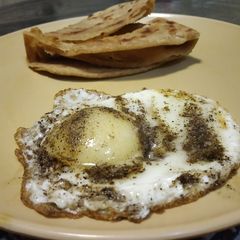 A picture of Half fry egg with laccha parantha.
