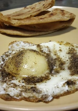 A picture of Half fry egg with laccha parantha.