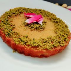 A picture of Bread kanafeh with pistachio crumble.