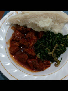 A picture of Meat stew,spinach served with ugali.