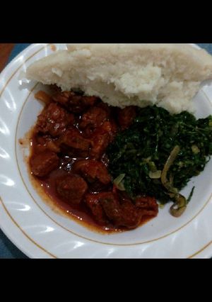 A picture of Meat stew,spinach served with ugali.