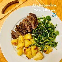 A picture of Pesto, Crusted Lamb Steak and Roast Potatoes with broccoli salad.