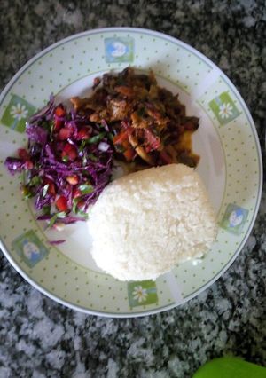 A picture of Stewed beef served with vegetable salad and Ugali.