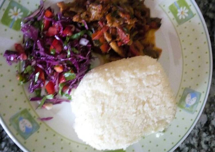 Stewed beef served with vegetable salad and Ugali