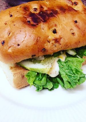 A picture of Subway style sandwich with raw mango slice.