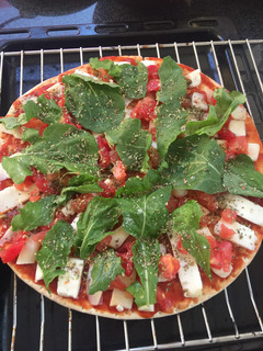 Una foto de Pizza albahaca, tomate y queso de cabra