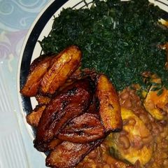 A picture of Porridge beans veggie with Titus fish and fried plantain.