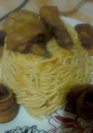 A picture of Spaghetti Delight with Fried Chicken & Fried Ripe Plantain rings.