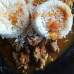 A picture of Beef stew served with rice.