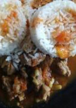 A picture of Beef stew served with rice.