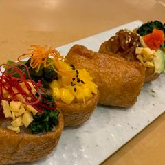 A picture of Inari Sushi / Sushi rice wrapped in a tofu bag. Good for Vegan.