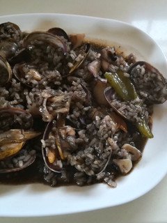 Una foto de Arroz negro con almejas y all y oli