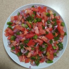 A picture of Tomato, green pepper and red onion salsa.
