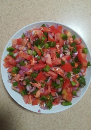 A picture of Tomato, green pepper and red onion salsa.
