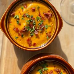 A picture of Carrot Ginger Soup w/ bacon.