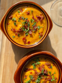 A picture of Carrot Ginger Soup w/ bacon.
