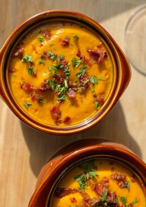 A picture of Carrot Ginger Soup w/ bacon.