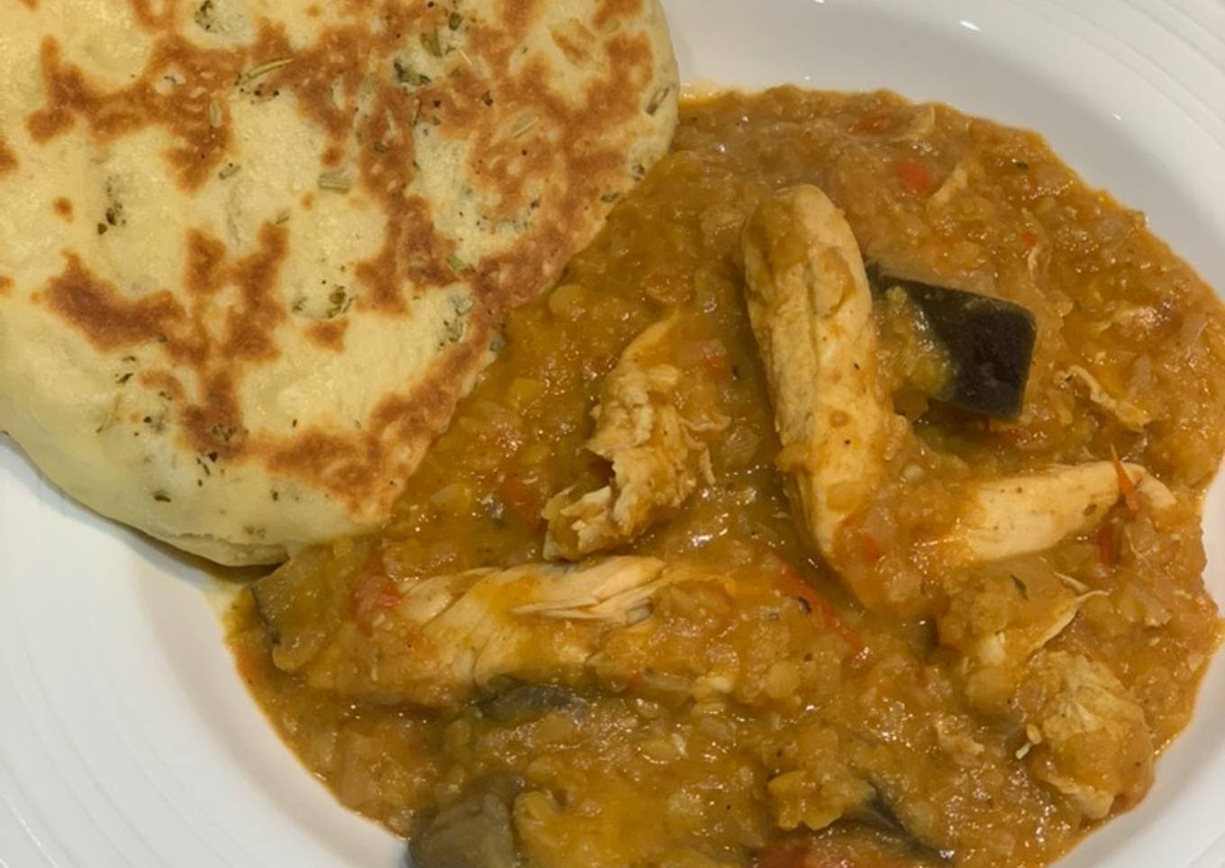 Red lentil chicken curry with aubergine and home-made naan bread for Jamo