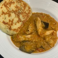 A picture of Red lentil chicken curry with aubergine and home-made naan bread for Jamo.