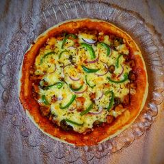 A picture of Chicken Tikka Pizza.