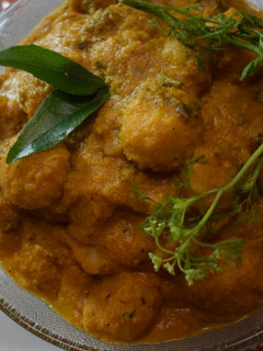 A picture of Mutkale - Rice Balls in red hot sauce with mutton.