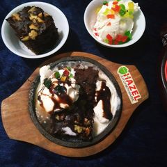 A picture of Walnut brownie with ice-cream.