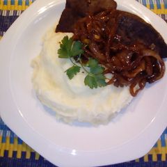 A picture of Ox Liver severed with Whipped buttery Mashed Potatoes.